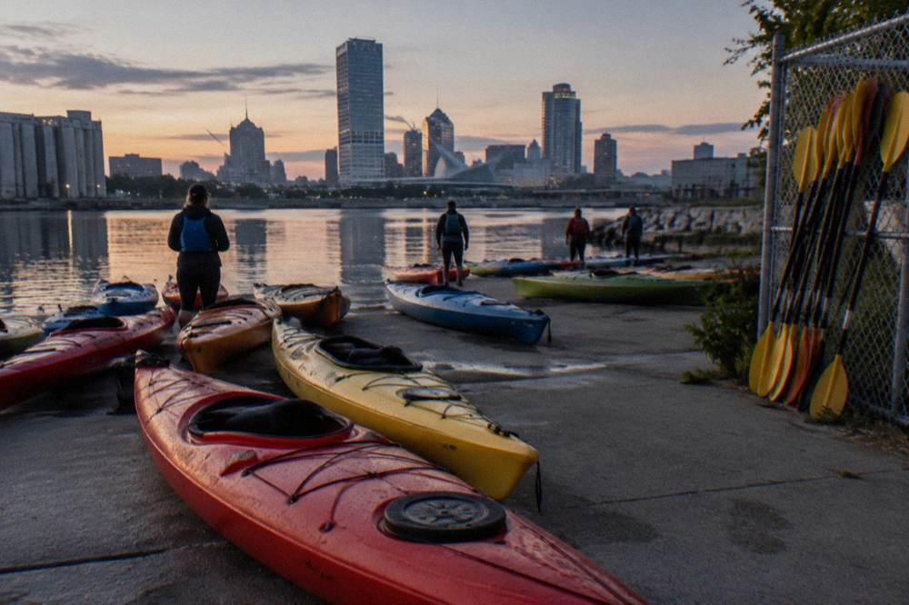 Kayaks grouped at a dock on the Milwaukee River before a guided tour departure